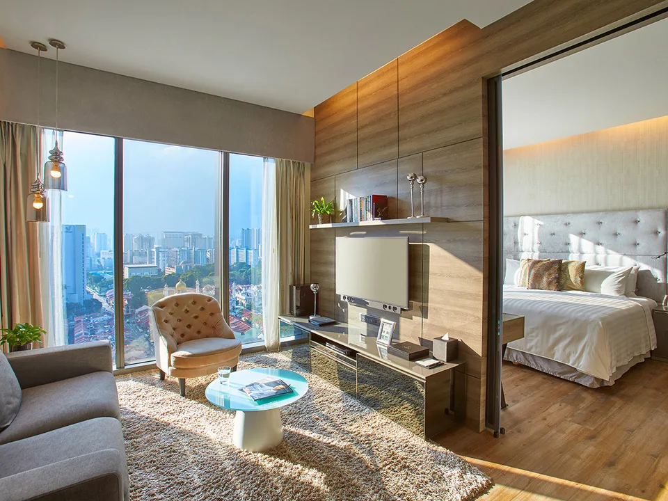 Living area beside a separate bedroom in a One Bedroom Executive Suite at Pan Pacific Serviced Suites Beach Road, Singapore.