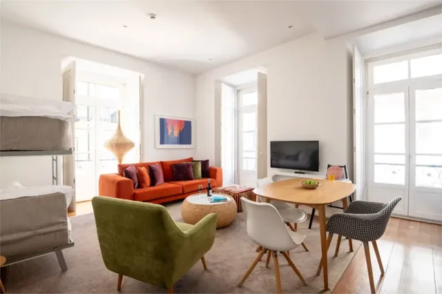 Living room with bunk beds, a sofa and a dining table in a One Bedroom Deluxe Apartment at Martinhal Chiado.